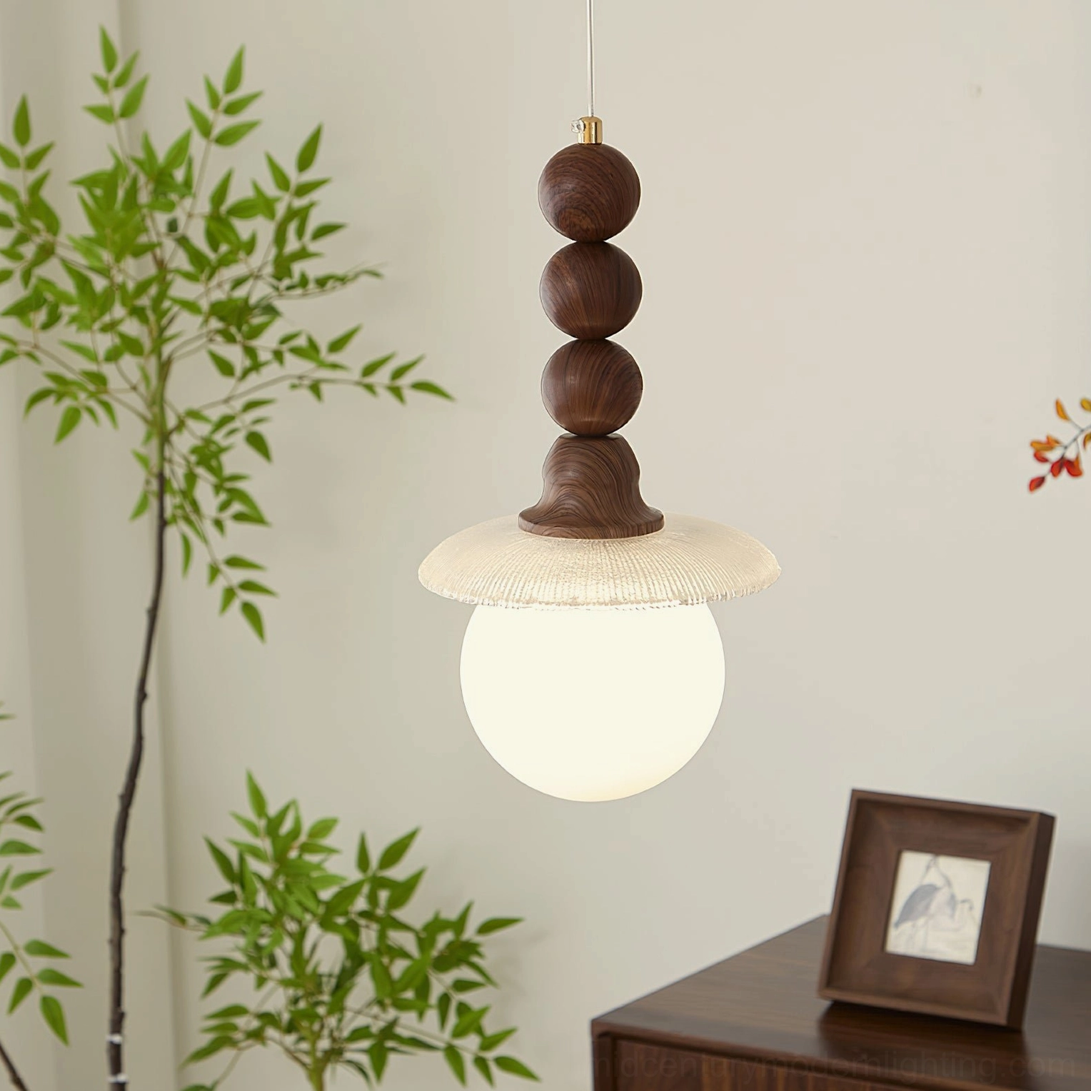 Kaydan frosted ball pendant light in warm mid-century modern setting with green plants