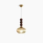 Kaydan mid-century modern pendant light with ribbed amber glass and brass hardware, studio white backdrop