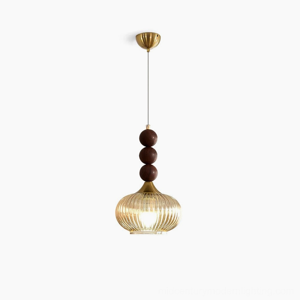 Kaydan mid-century modern pendant light with ribbed amber glass and brass hardware, studio white backdrop