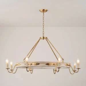 Side profile of Kayleigh chandelier with brass suspension chain, gilded acanthus leaf decorations, and distressed white circular frame against off-white background