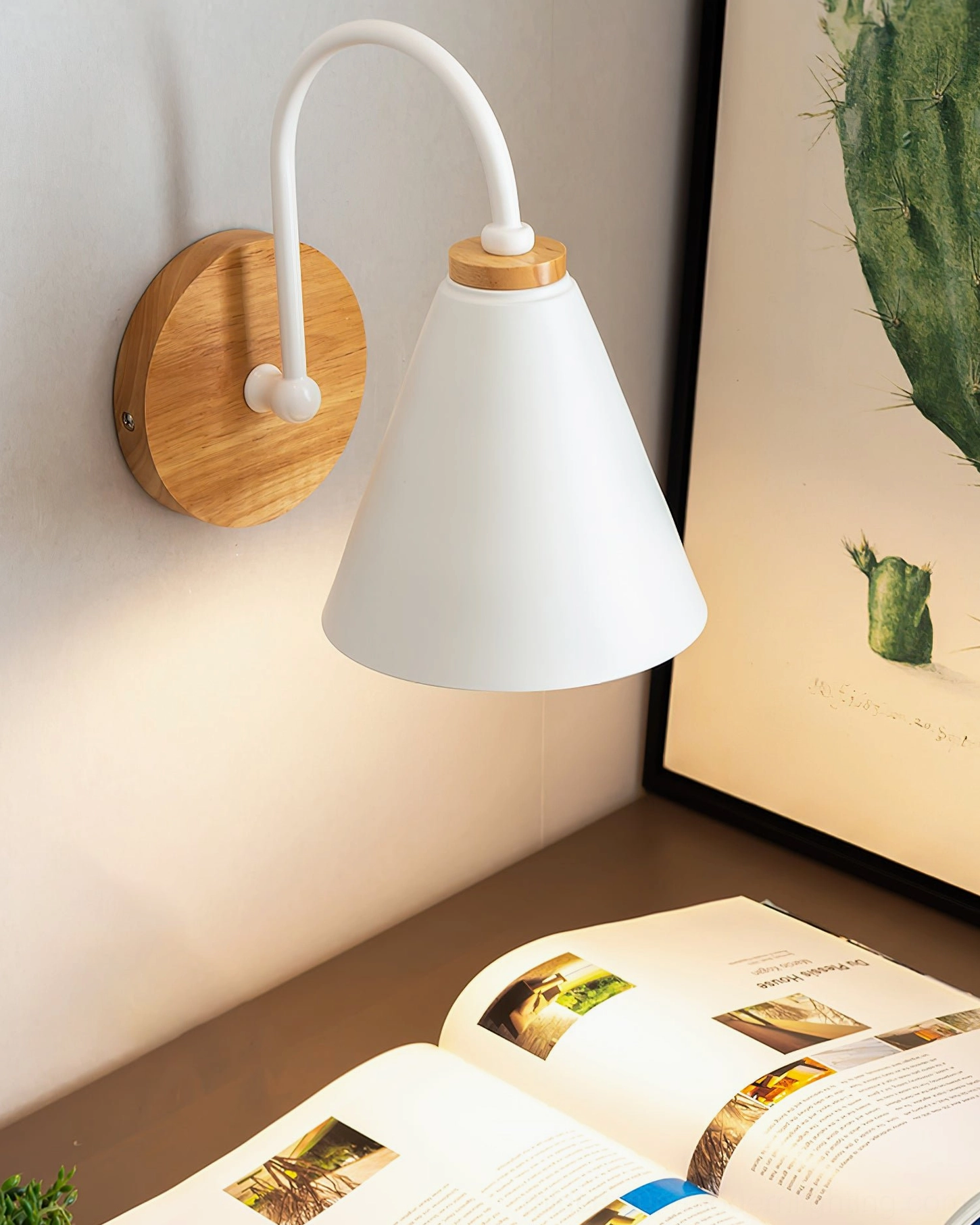 Kenji Nordic wall sconce in minimalist desk setting with reading material and side angle view of contemporary design
