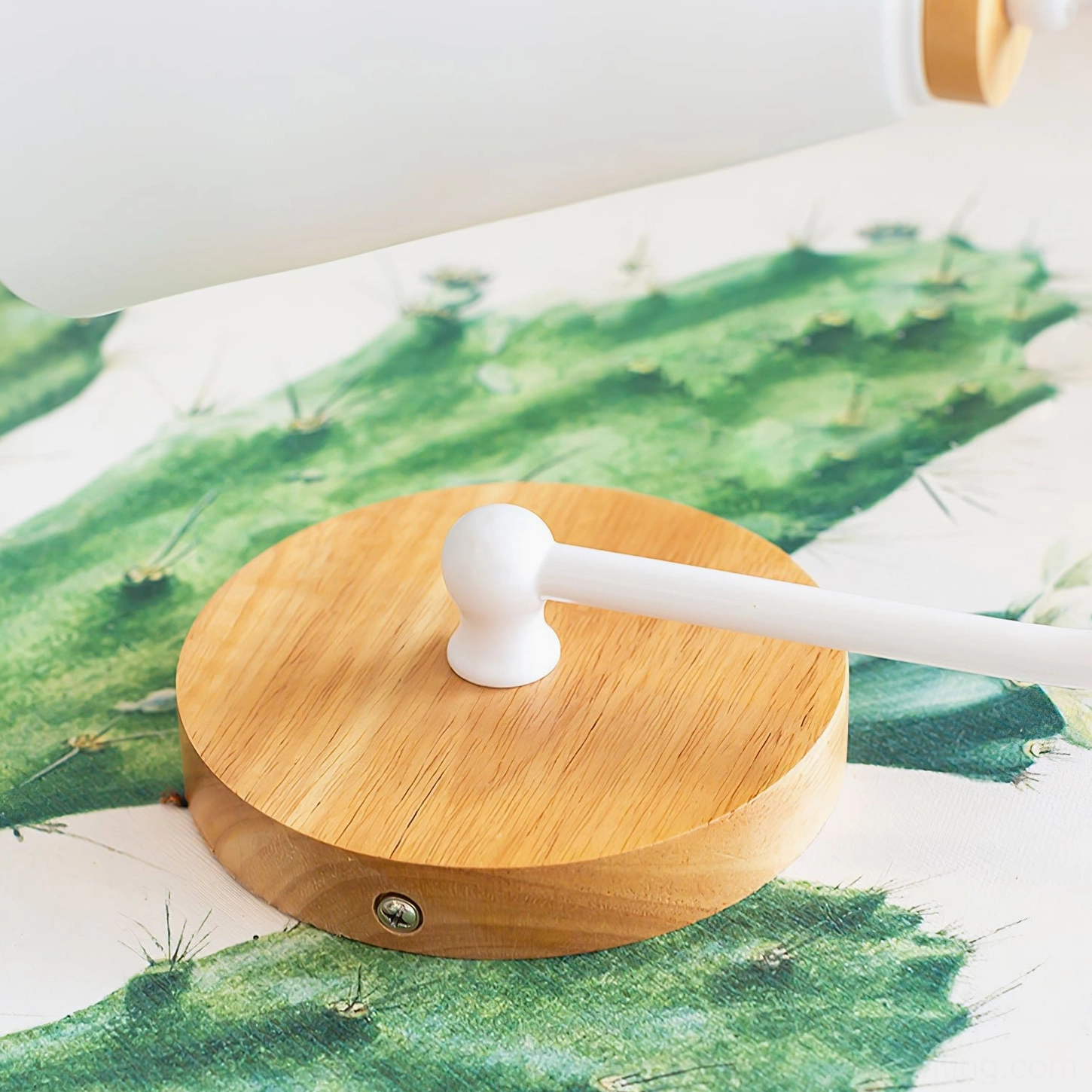 Kenji wall lamp hardware components top-down view showing round solid wood mount and white metal fixture assembly