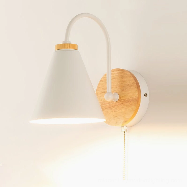 Detailed view of Kenji wall lamp arm and natural wood base showing Scandinavian minimalist construction and materials