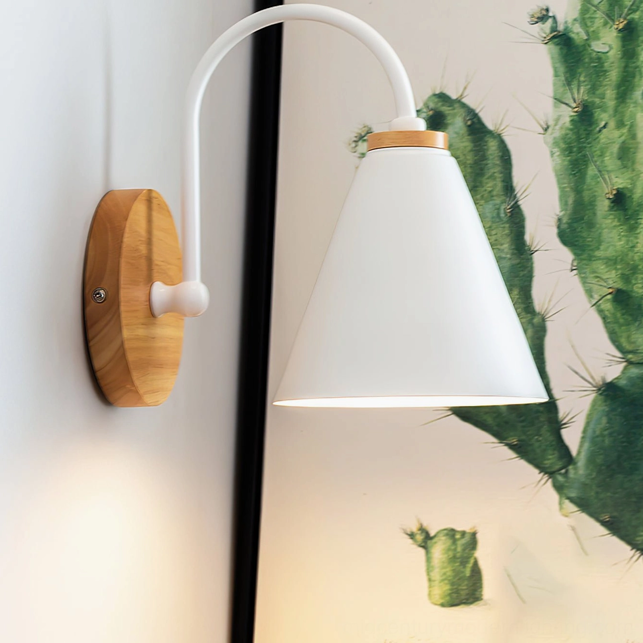Kenji wall sconce side angle showing solid natural wood wall plate mounting and curved white metal arm structure