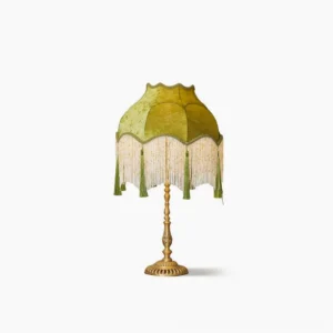 Kennedy mid-century modern table lamp with sage green scalloped velvet shade and brass base, studio view against white background