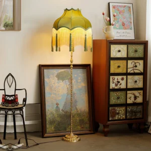 Kennedy vintage green floor lamp displayed in romantic vintage home corner with artwork and storage cabinet