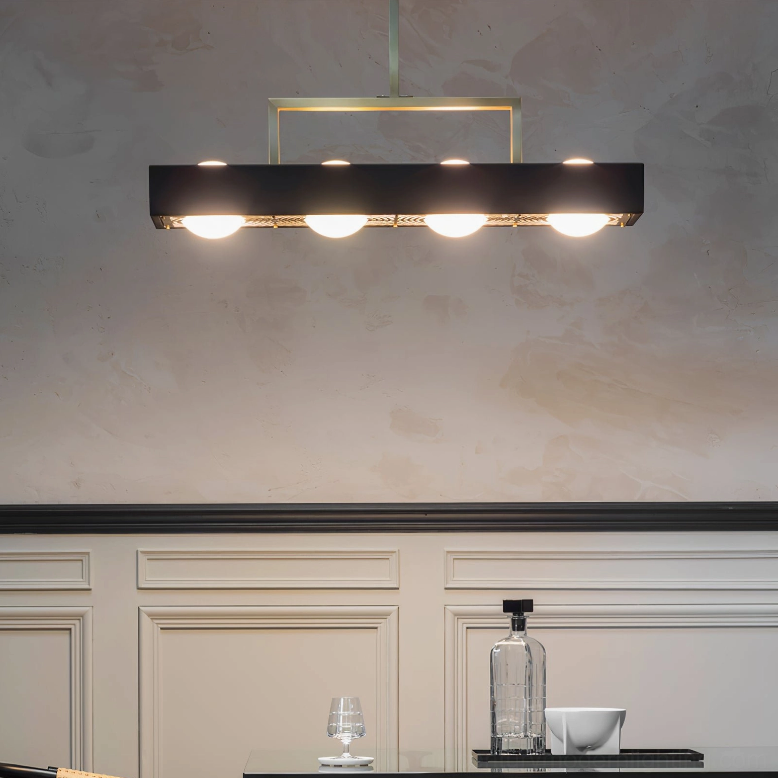 Kernel geometric pendant illuminated in dining room with wainscot wall design