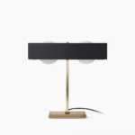 Kernel mid-century modern table lamp with dual frosted glass globes and solid metal base, front view on white background