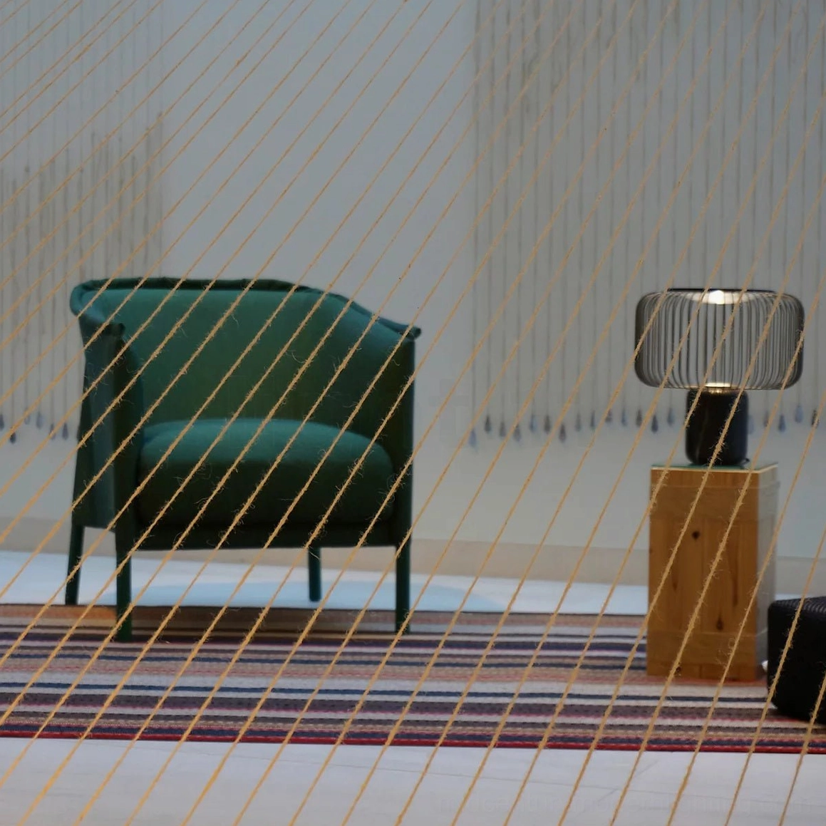 Keshi table lamp three-quarter angle showing matte black metal construction and marble base