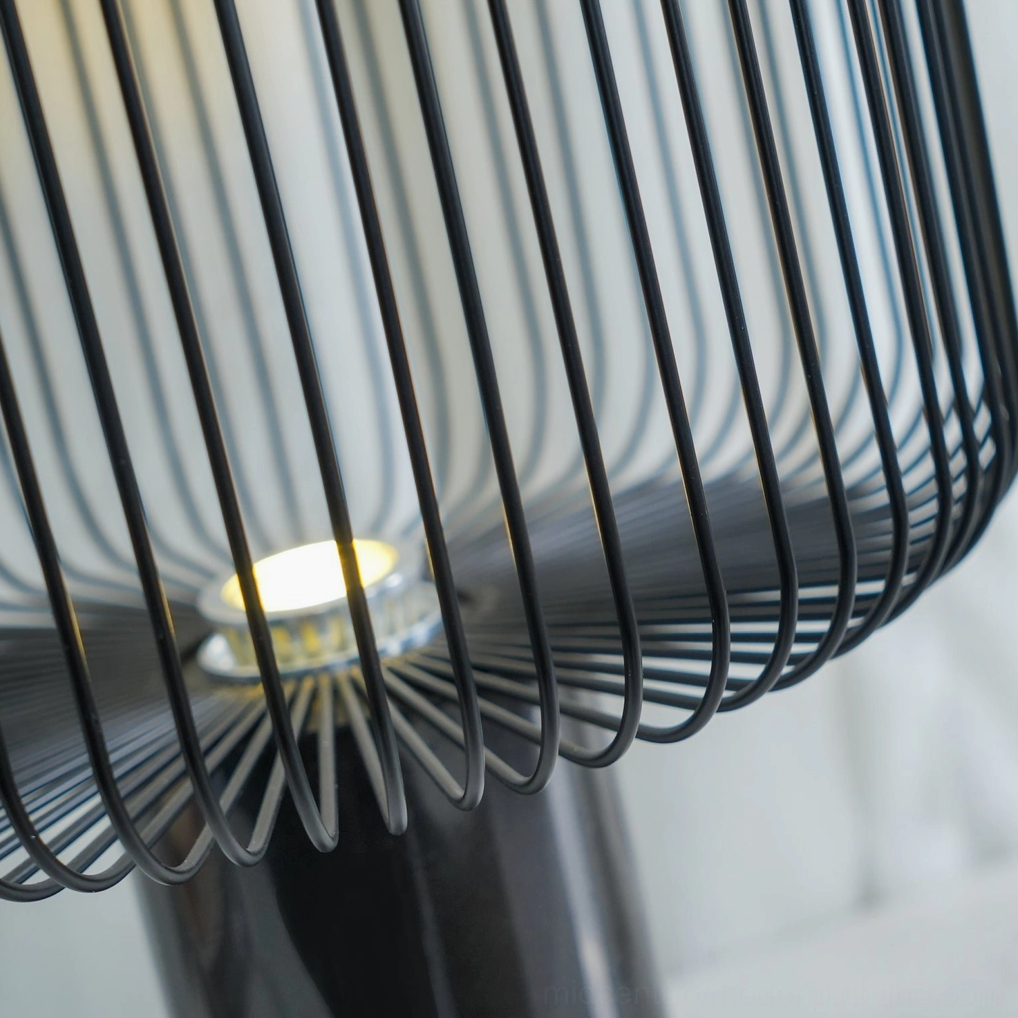 Keshi table lamp interior close-up showing integrated warm LED bulb and radial metal cage structure