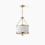 Kian drum pendant light with white fabric shade and gold metallic accents, front studio view