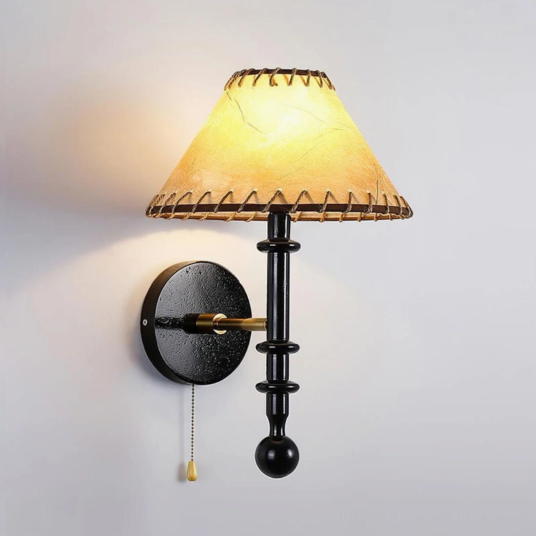 Black Kibo wood wall sconce installed in modern bedroom displaying elegant minimalist aesthetic and soft ambient light