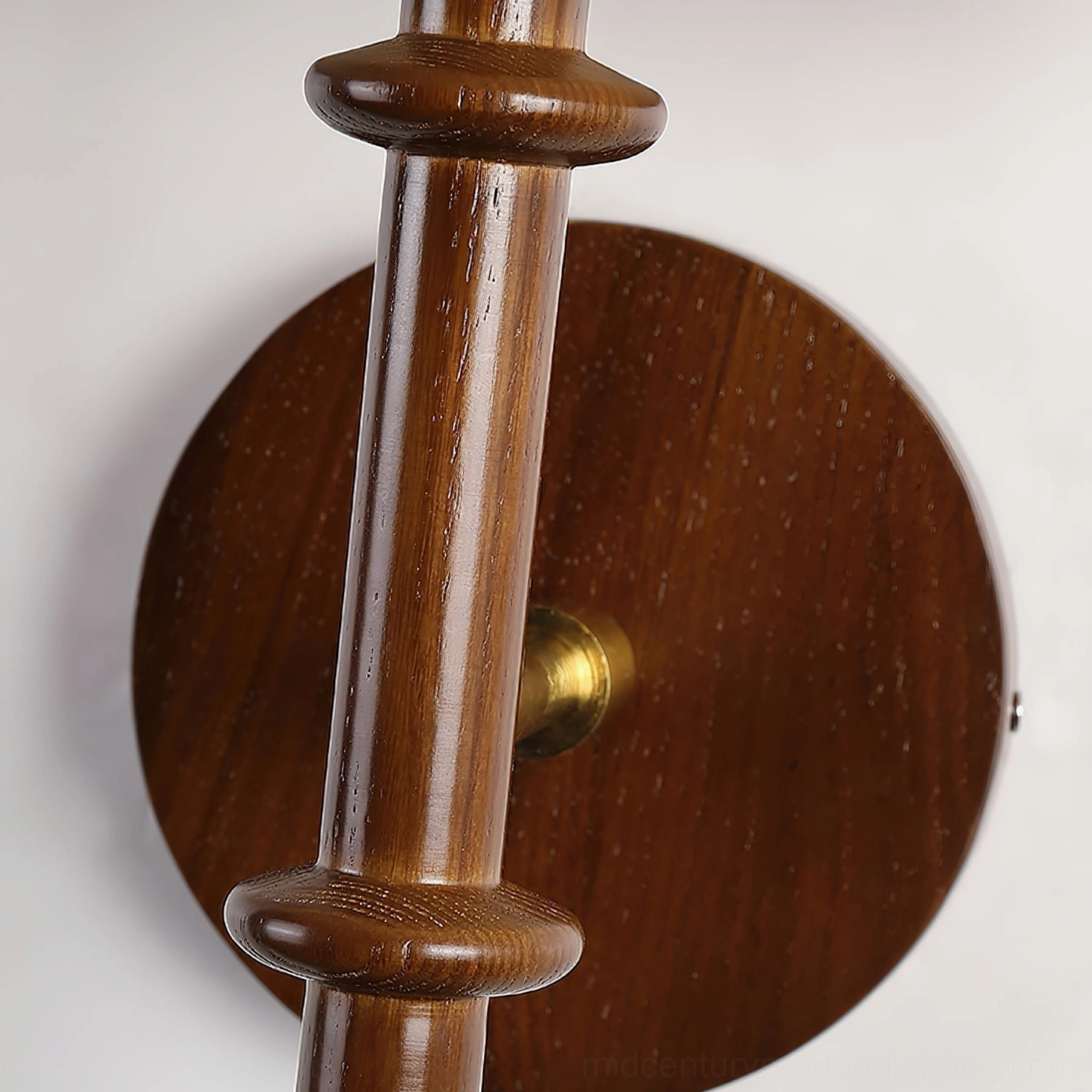 Kibo wood wall sconce installed in bedroom setting showing scale and proportions with furniture context