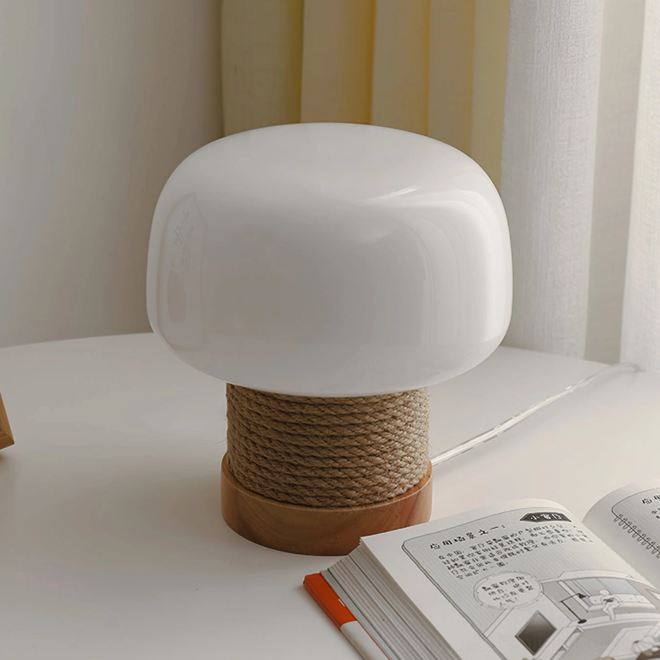 Organic modern mushroom lamp on white desk with books and stationery