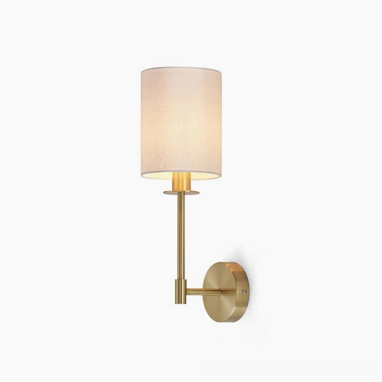 Kington compact brass wall sconce with cylinder linen shade in white background studio setting