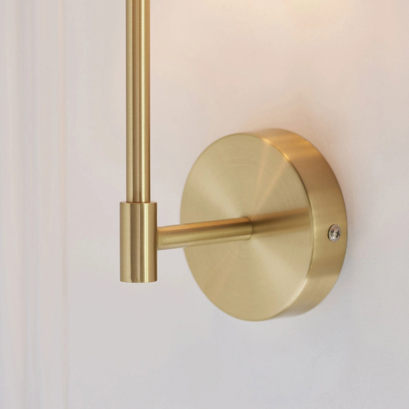 Kington sconce linen shade close-up with illuminated interior and brass base attachment