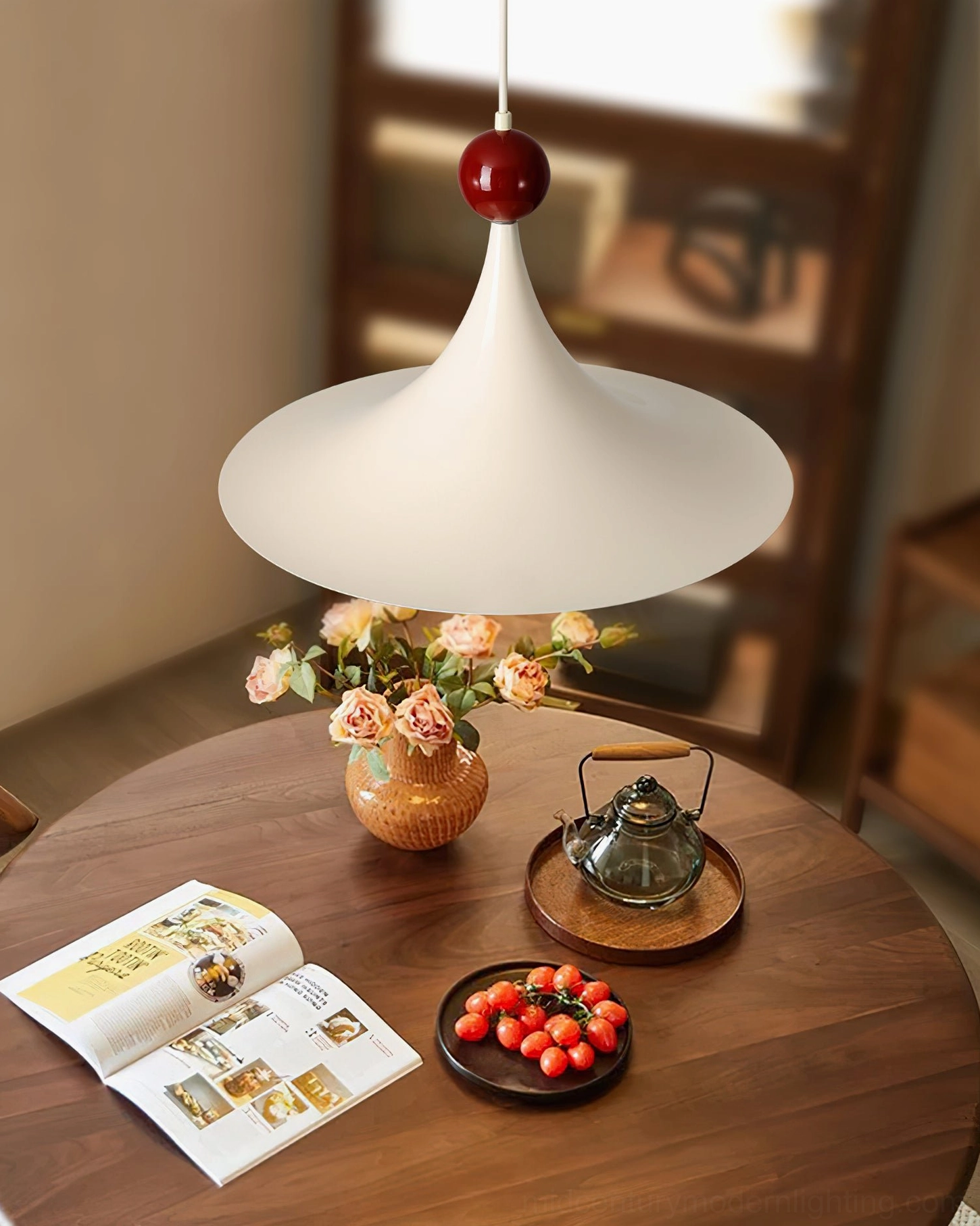 Kinvara pendant light installed above wooden dining table in modern dining room setting