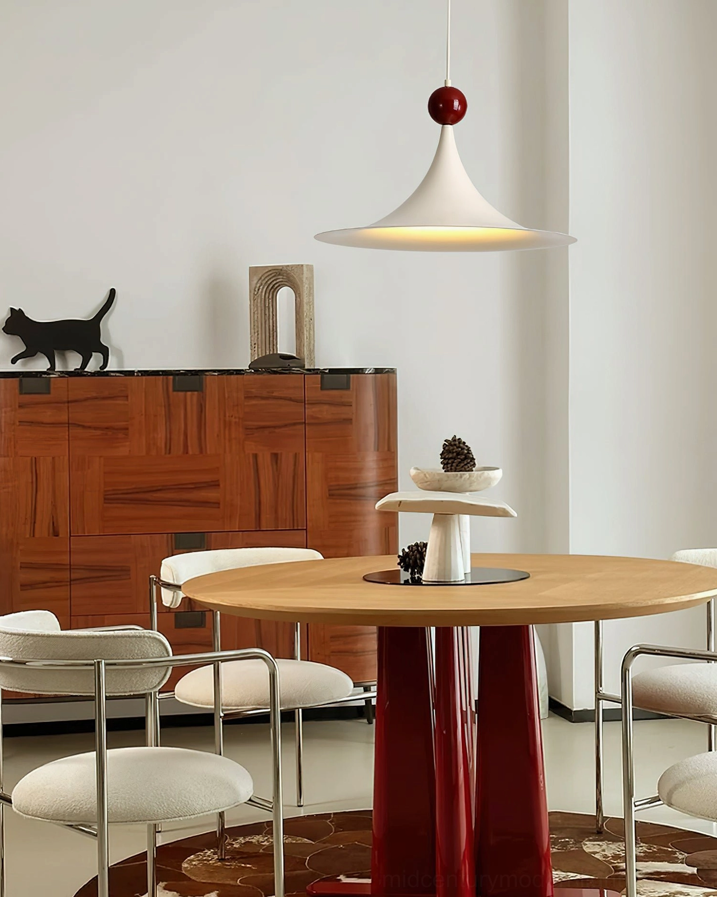 Side view of Kinvara mid-century modern pendant hanging in warm minimalist dining space with wooden furniture