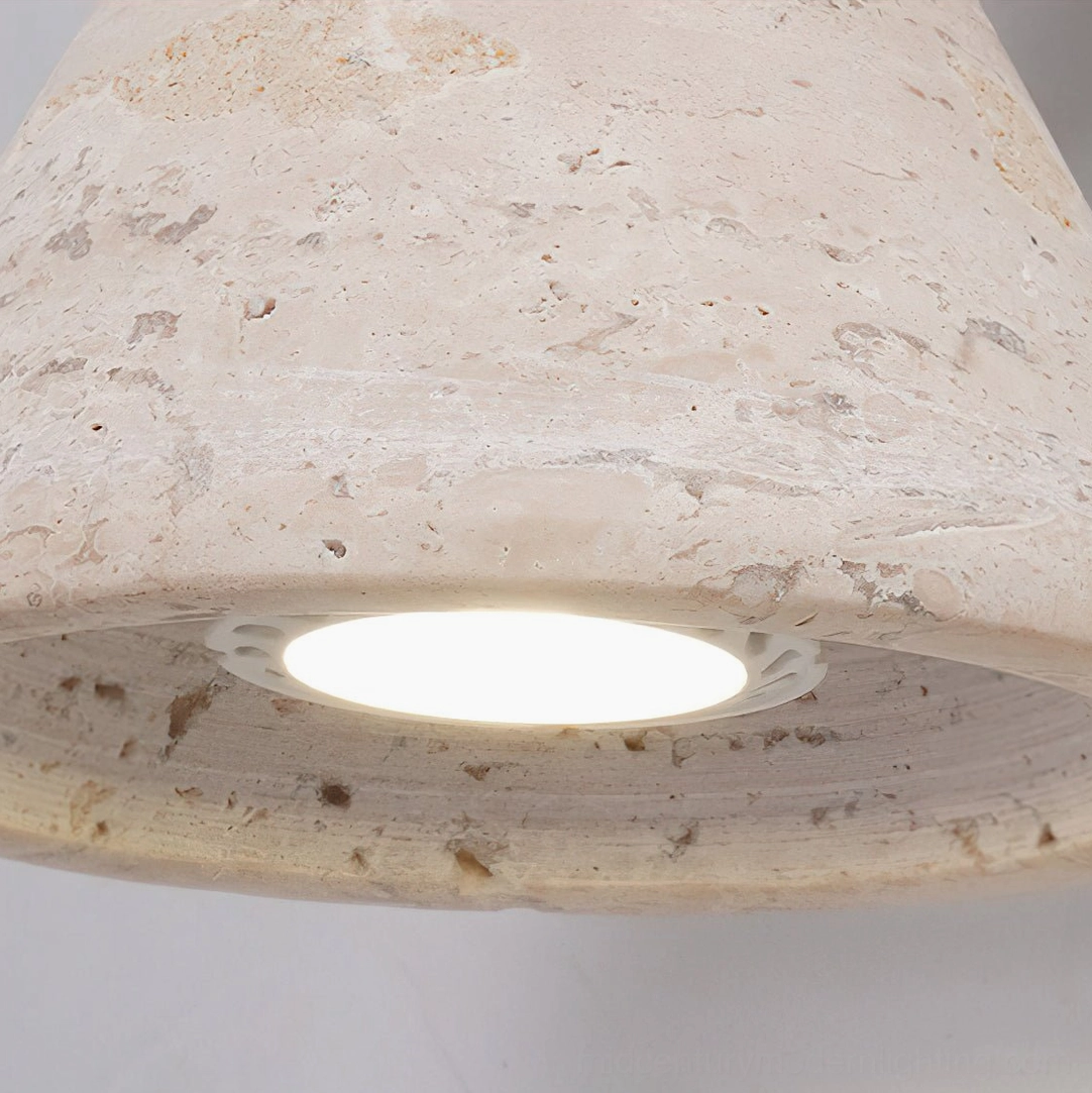 Kiran travertine wall sconce with black and walnut finish on architectural feature wall