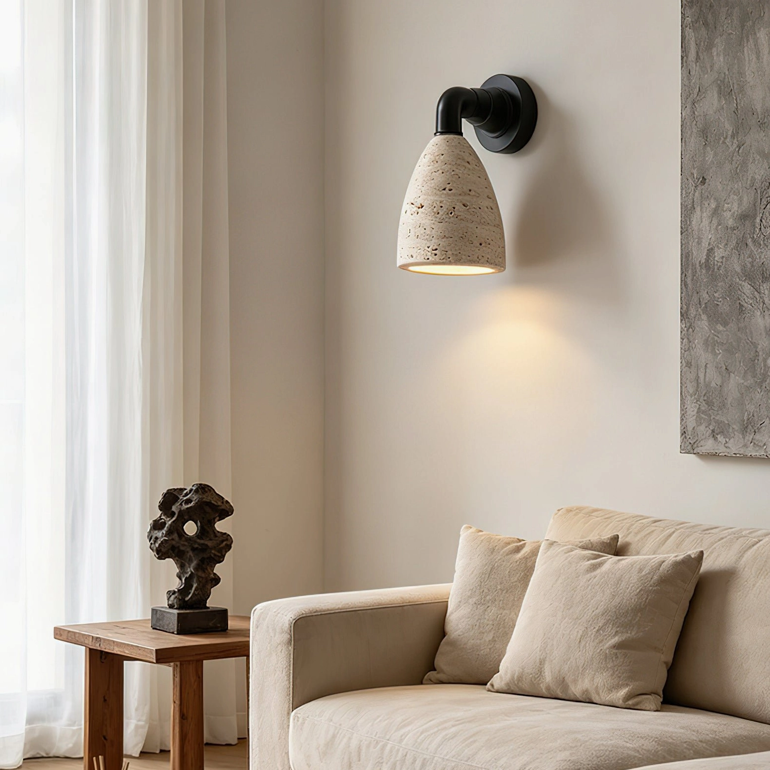 Kiran tapered travertine wall sconce in boho living room with sofa and neutral minimalist rustic aesthetic