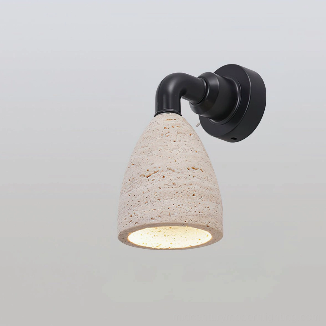 Kiran travertine wall sconce Model B compact size mounted on gallery wall with minimal aesthetic