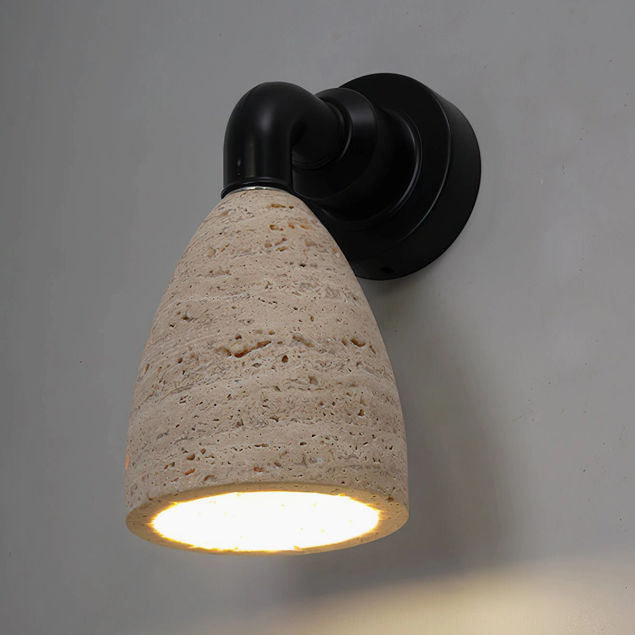 Kiran travertine wall light mounted pair flanking bedroom headboard creating symmetrical ambiance