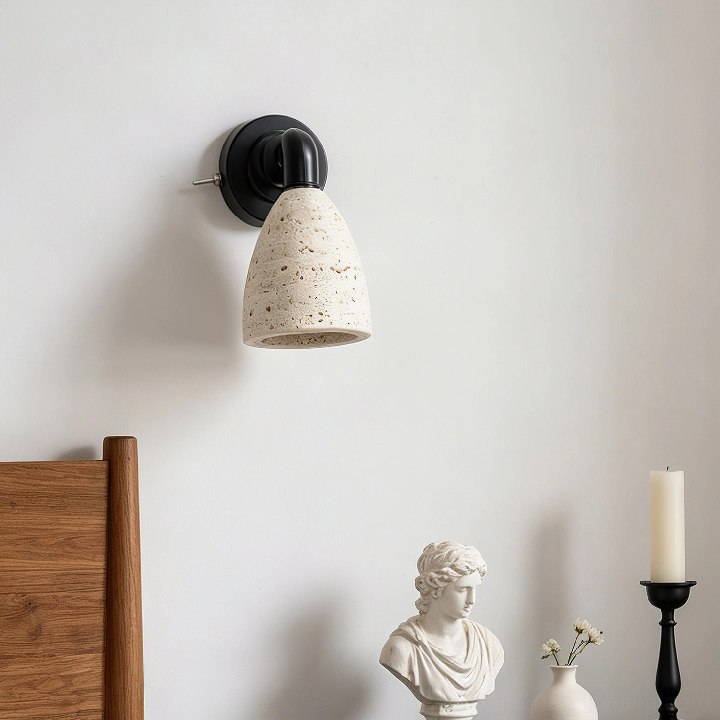 Kiran travertine wall sconce with tapered conical shade casting artistic shadows in bedroom interior