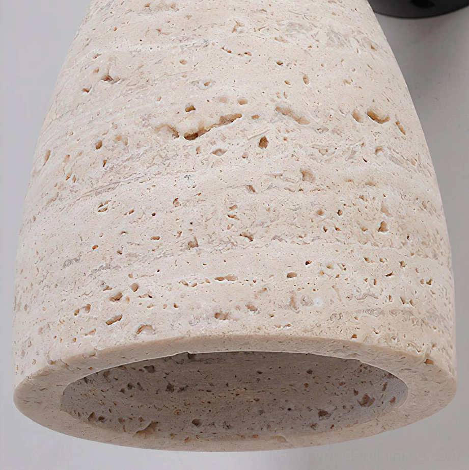 Kiran travertine wall sconce close-up showing natural stone texture, veining, and craftsmanship details