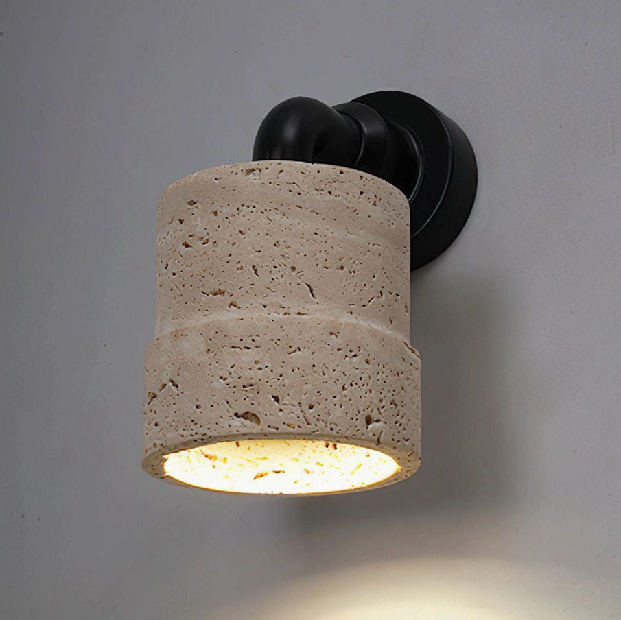 Kiran natural travertine wall light with warm diffused downlight in contemporary interior setting