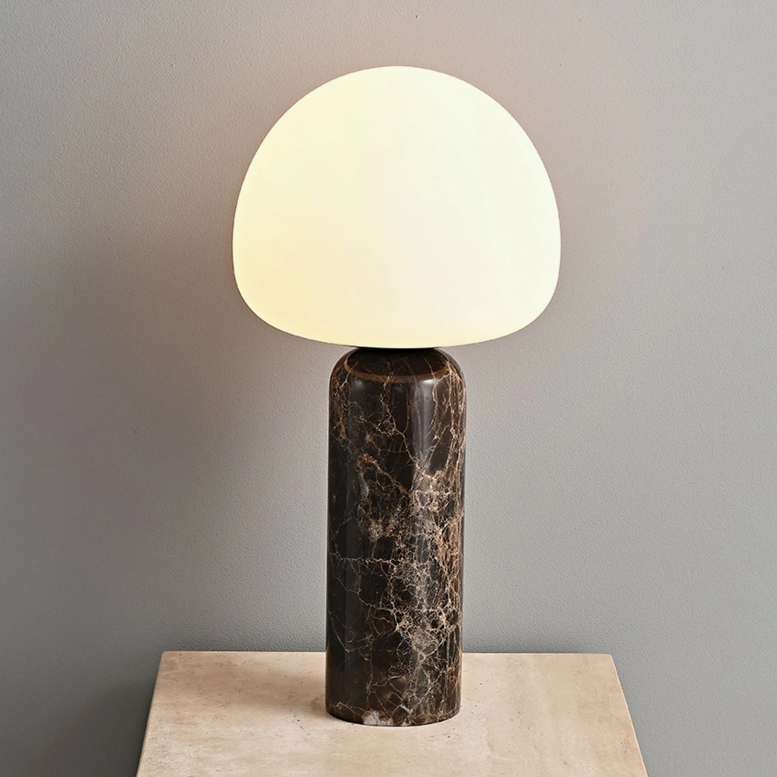 Tall Model B Kizu table lamp with white frosted glass shade and dark marble base overhead view
