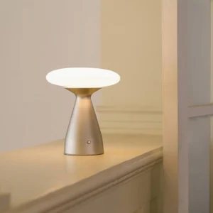 Klaus cordless lamp illuminated on wooden console table with warm ambient lighting and minimalist Nordic design