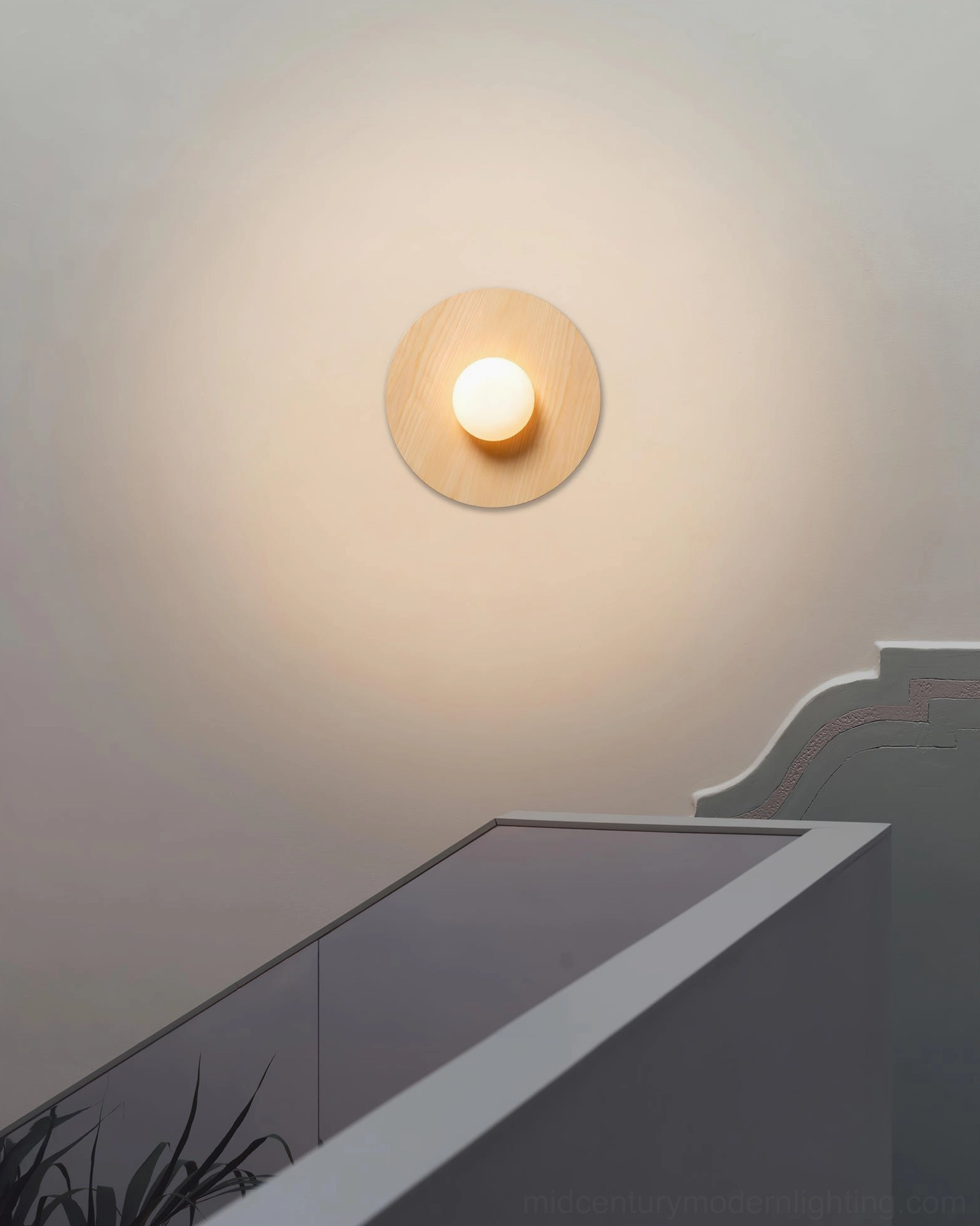 Knock modern round wall lamp in bedroom with eye-level mounting, black bracket detail contemporary design