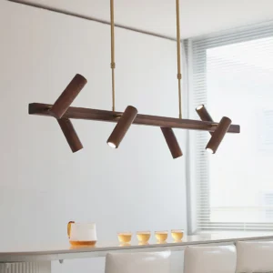 Konnect pendant light installed in modern dining room with warm ambient lighting, low angle interior perspective showing rotatable arms in contemporary setting