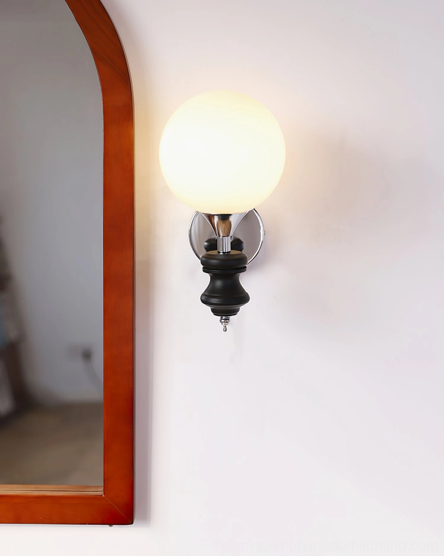 Koscina globe sconce - soft diffused illumination through frosted glass creating warm ambient light