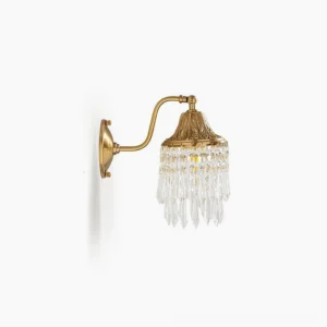 Kristall brass crystal wall lamp left side front view featuring embossed leaf details and hanging crystal pendants