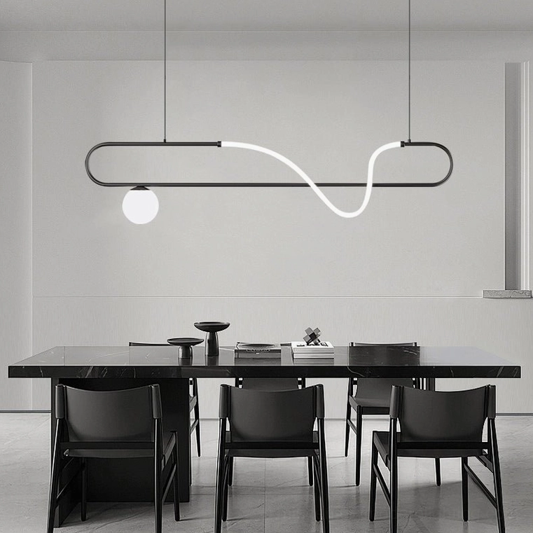 Matte black Kulgony linear pendant chandelier over long dining table in modern dining room