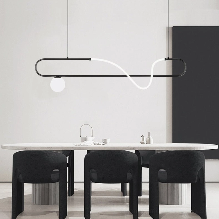 Matte black Kulgony linear pendant light in white dining room with black chairs