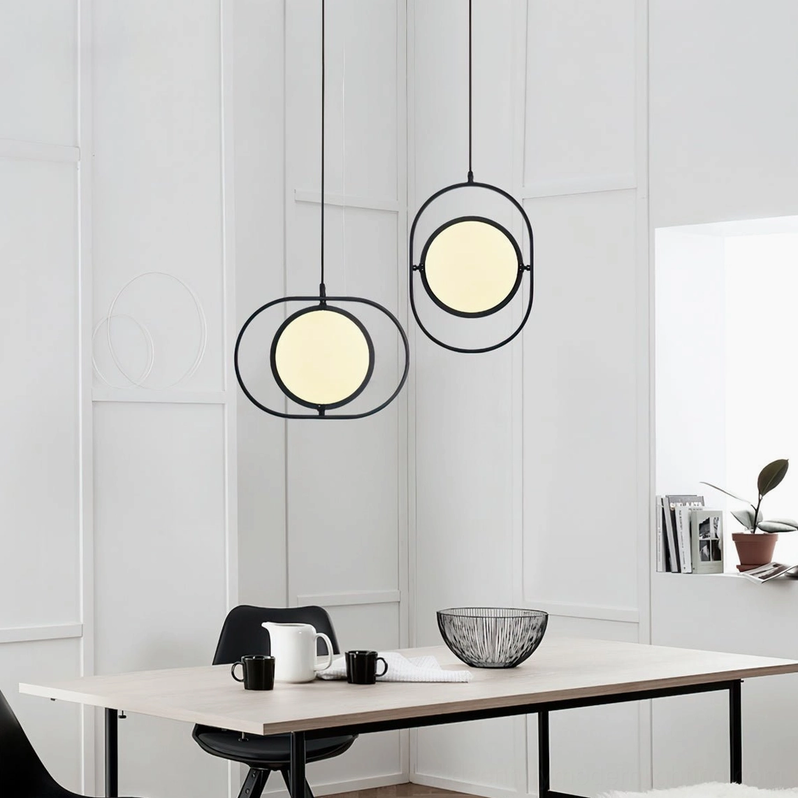 Two Kuu circular pendant lamps in modern minimalist white dining area glowing panels