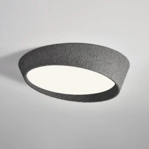 Kuzco textured ceiling light mounted indoors with warm white LED glow