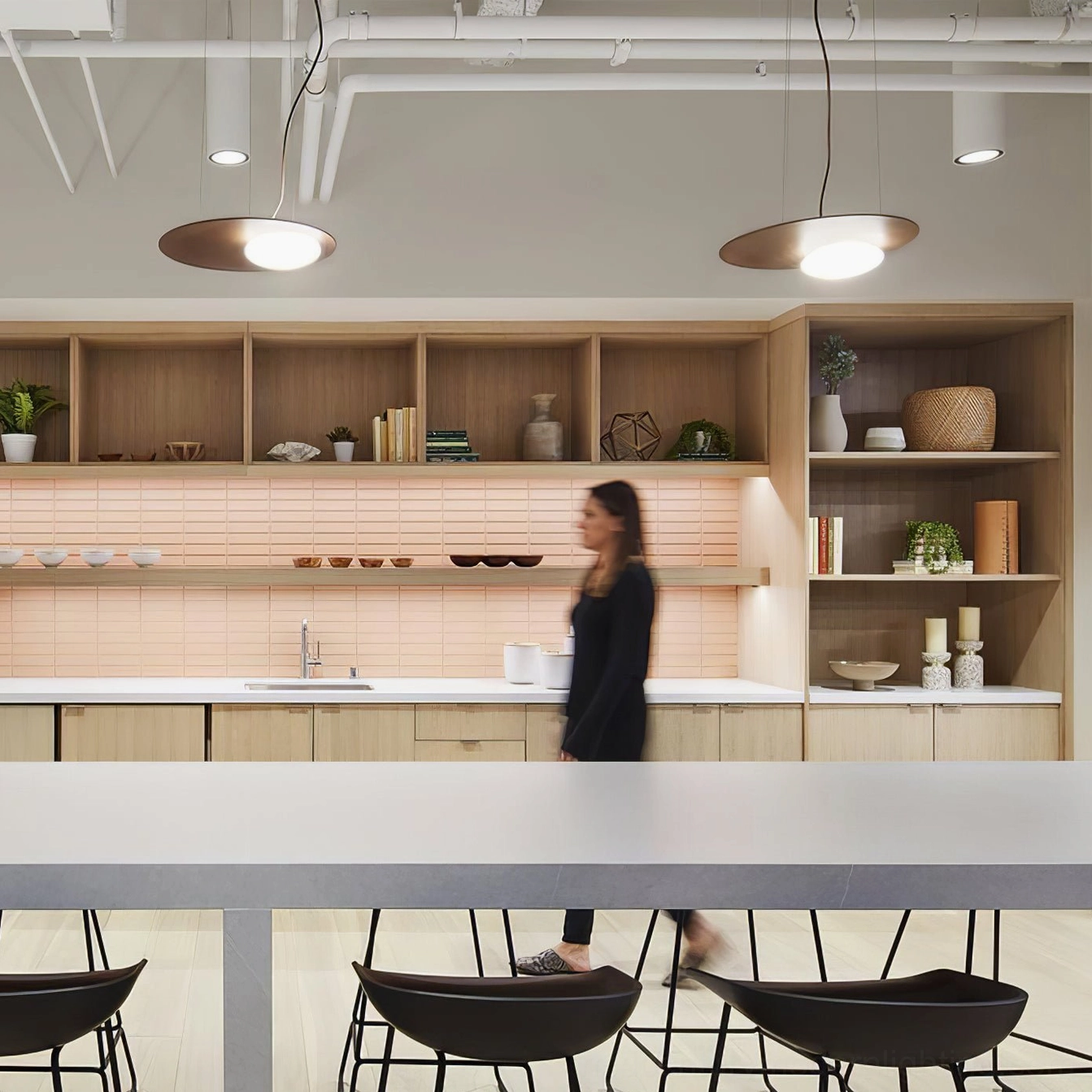 Brushed gold Kwic disc pendant lamps installed in modern commercial office kitchen break room