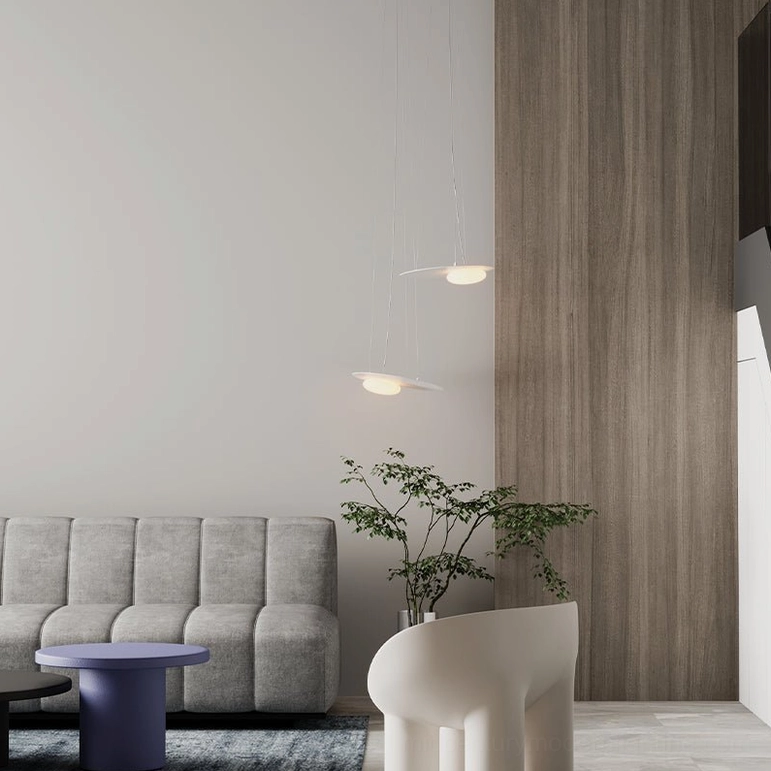Small Kwic disc pendant lamps with warm illumination in minimalist modern living room with neutral decor