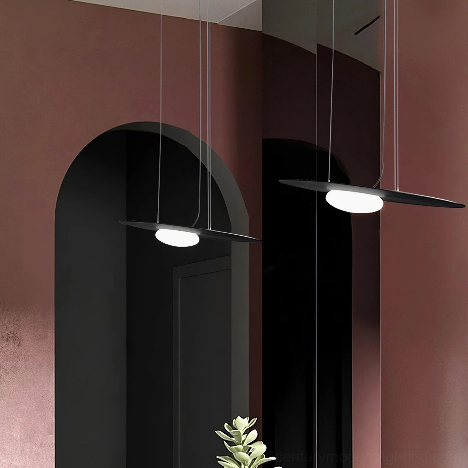 Triple Kwic disc pendant lights in mixed black and white finishes under arched doorway, luxury modern interior design