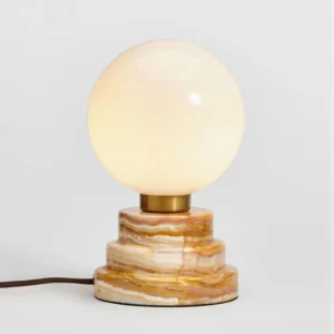 Illuminated Lakeville lamp with warm LED glow, visible power cord and brass accents