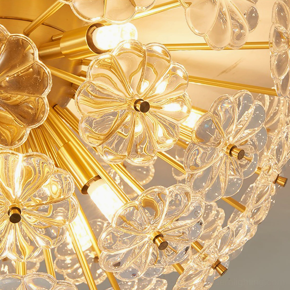 Lamina ceiling light macro close-up showing exposed bulb, gold metal arms, and intricate glass petal details