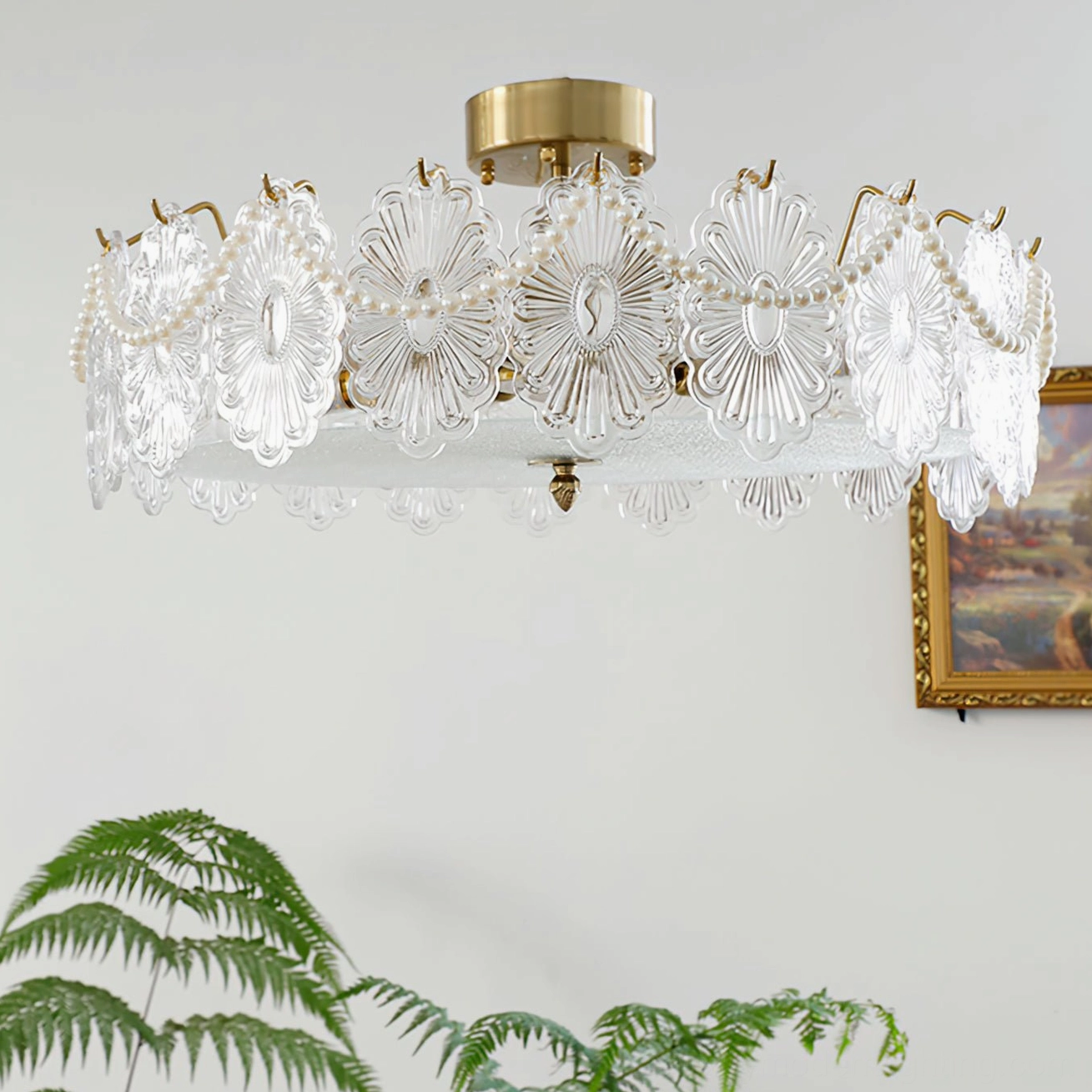 Lamina brass ceiling fixture with carved glass shades above minimalist gallery wall
