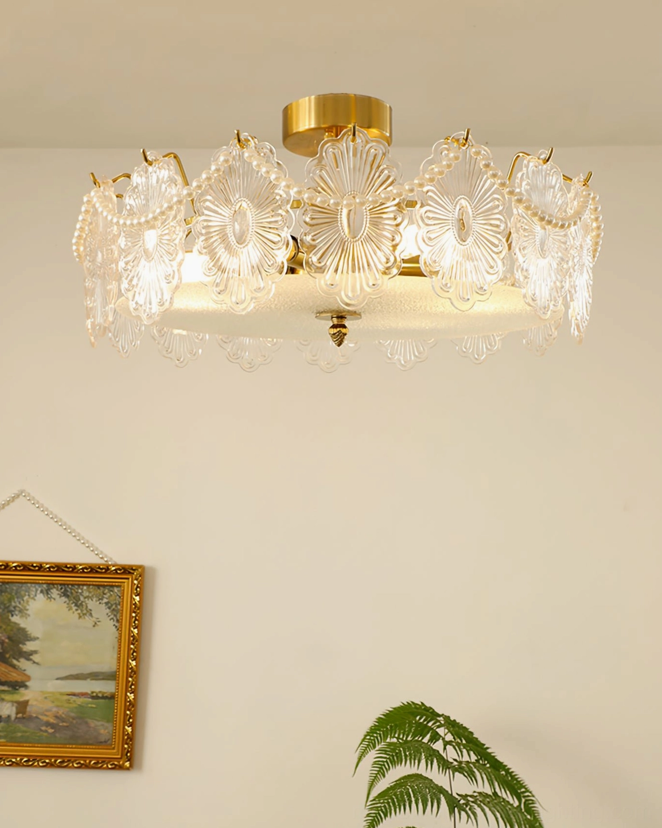 Lamina ceiling lamp lit with warm glow against minimalist wall with botanical decor