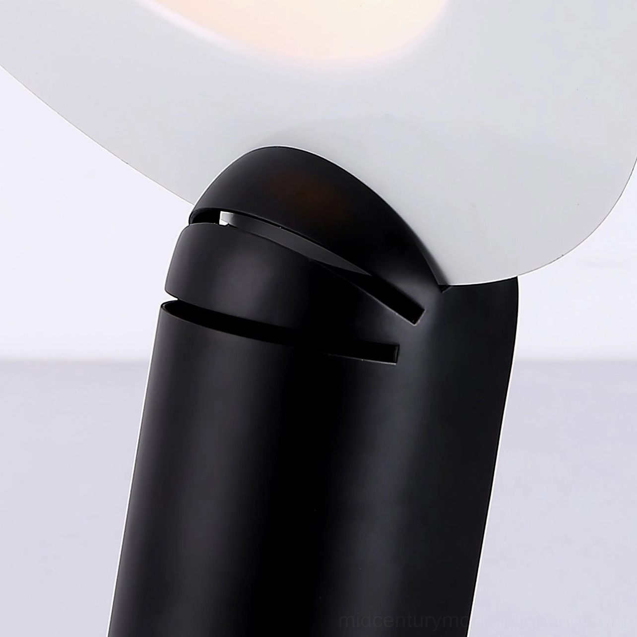 Lampiatta table lamp adjustment joint mechanism in matte black, showing rotational capability and directional control