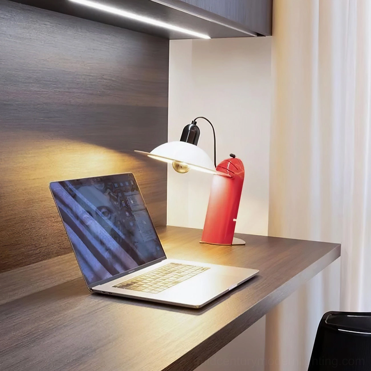 Lampiatta black disc table lamp with exposed bulb mechanism and rotational adjustment for adaptable light direction