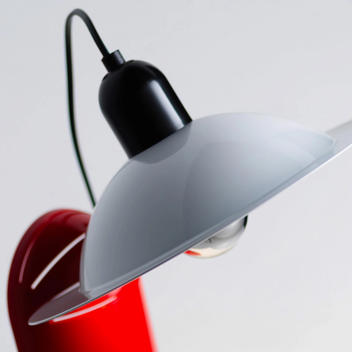 Lampiatta disc table lamp detail with grey shade, adjustable aluminum joint, and partial red base visible