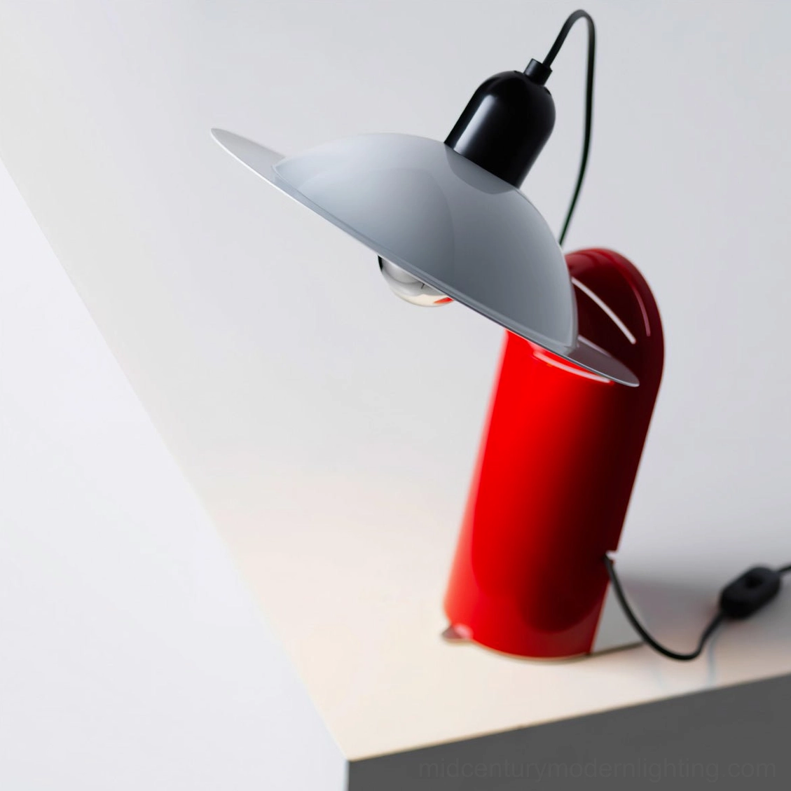 Close-up detail of Lampiatta table lamp with grey disc shade, red metal base, and exposed Edison bulb